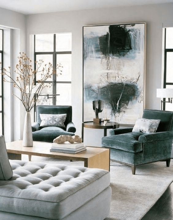 Best-Pro-Tips-to-Create-a-Focal-Point-in-a-Room-with-oversize-artwork-modern-blue-chair-living-room