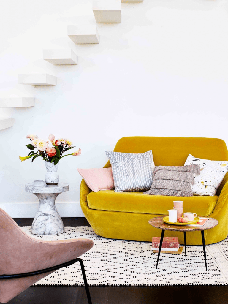 modern-yellow-love-seat-with-different-patterned-throw-pillows