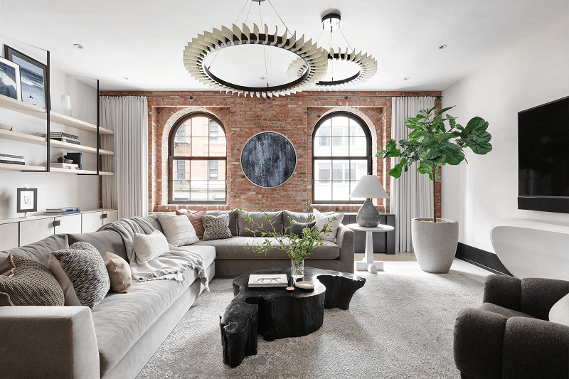 contemporary-living-room-with-grey-sectional-and-brick-wall