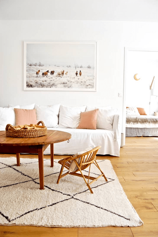 white-living-room-with-slipcovered-sofa-and-area-rug