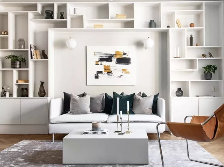 Scandinavian-living-room-with-white-floor-to-ceiling-bookshelves
