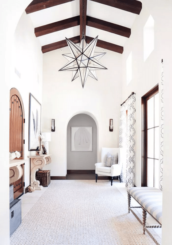 All-white-Entryway-foyer-with-a-cozy-chair-and-large-star-light-fixture