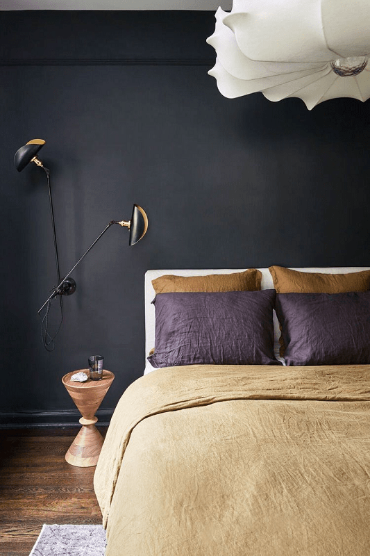 Bedroom-with-black-bold-walls-and-modern-large-ceiling-light-and-wall-swing-arm-light-fixture